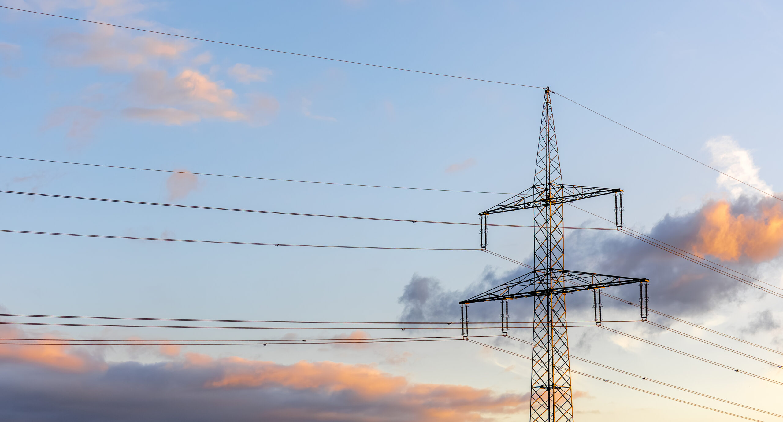 highvoltage-line-sunset-electricity-modern-design-scaled.jpg